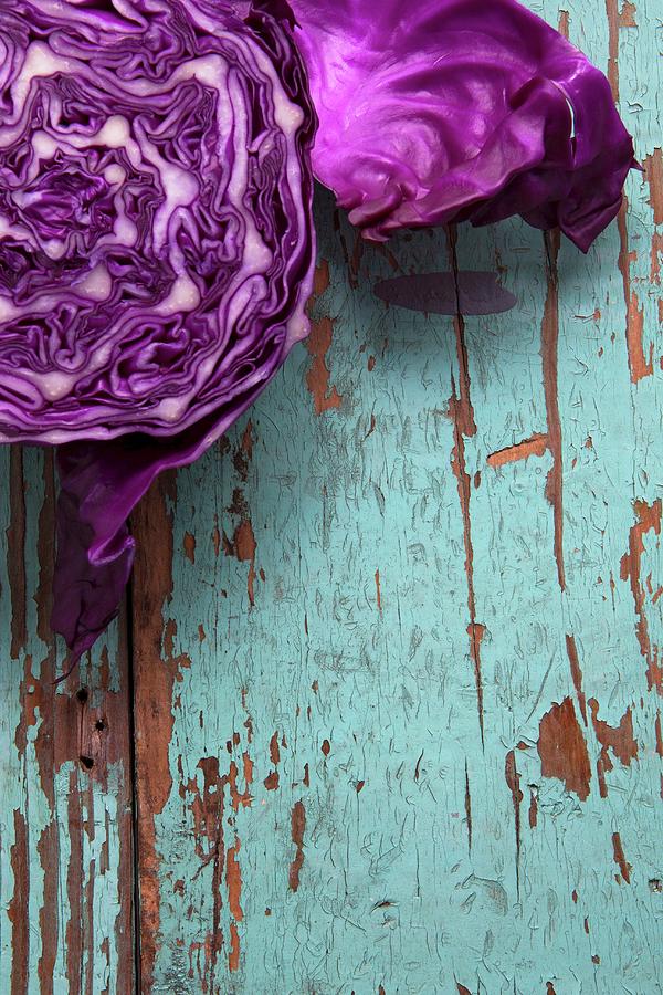 Red Cabbage On A Rustic Wooden Board Photograph by Vfoodphotography
