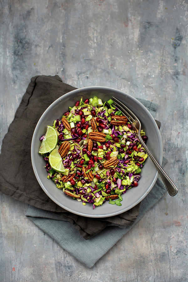 Red Cabbage Salad With Pecan Nuts, Lime And Pomegranates Photograph by Lara Jane Thorpe