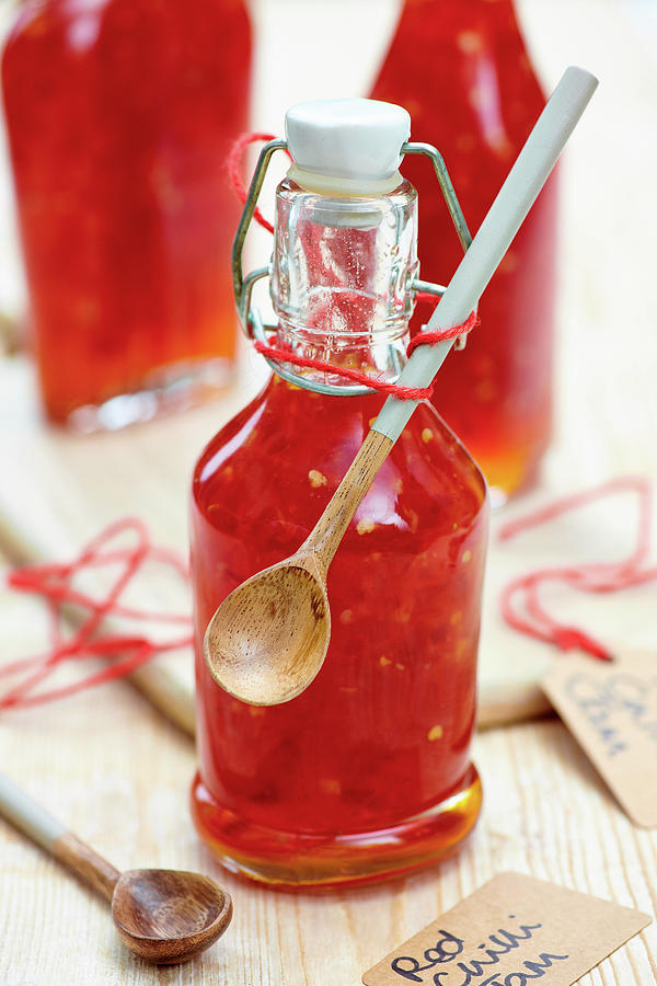 Red Chili Jam In A Bottle With A Wooden Spoon For Gifting Photograph by Jonathan Short
