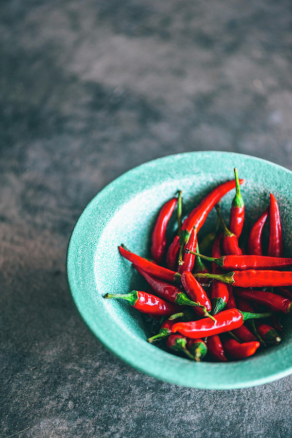 Red Chillies In A Blue Bowl Photograph by Hein Van Tonder