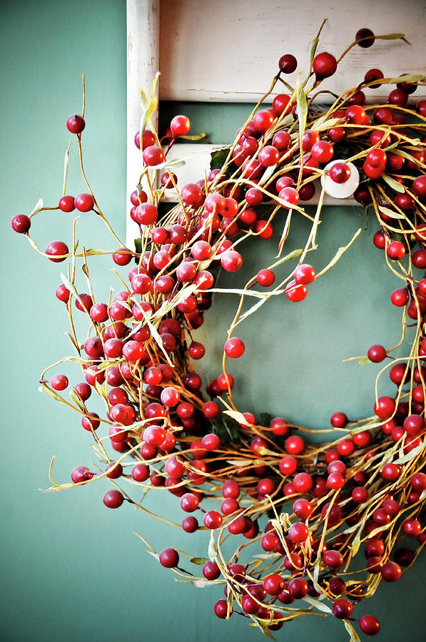 Red Cranberry Wreath Against Blue Wall Photograph by Photo By Sam Scholes