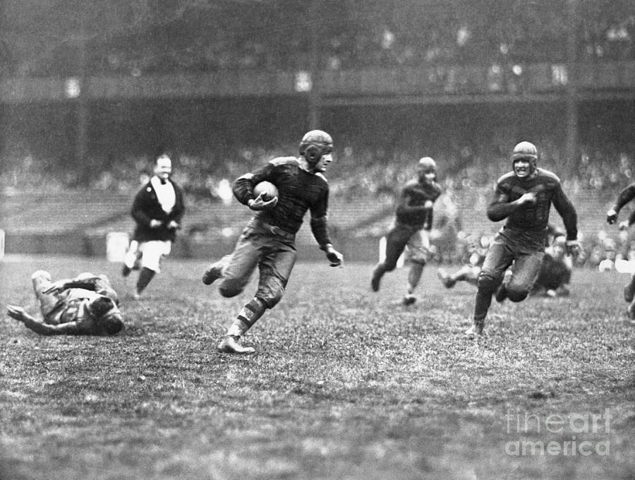 Red Grange Carrying Football Photograph By Bettmann