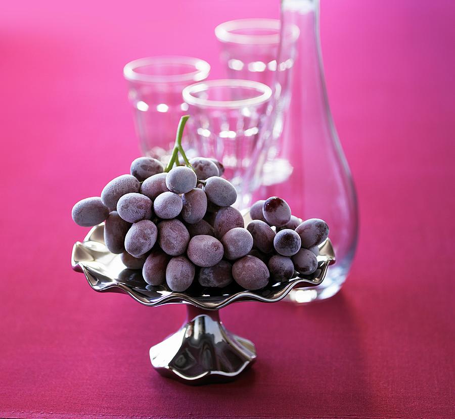 Red Grapes On A Silver Platter With An Empty Carafe And Glasses In The Background Photograph by Vincent Noguchi Photography