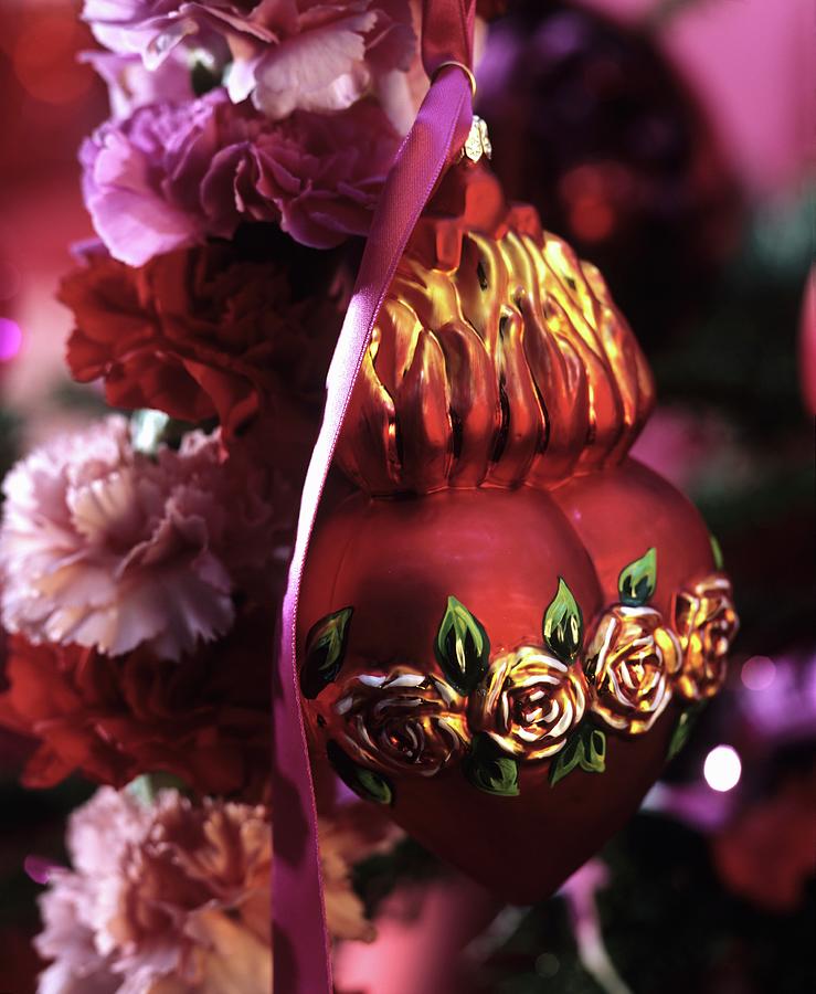 Red, Heart-shaped Christmas Tree Bauble With Rose Motif On Carnation Wreath Photograph by Matteo Manduzio