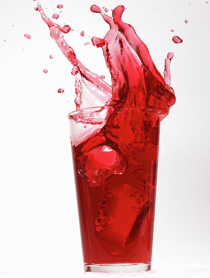 Red Juice Spilling From Glass Photograph by Alex Cao