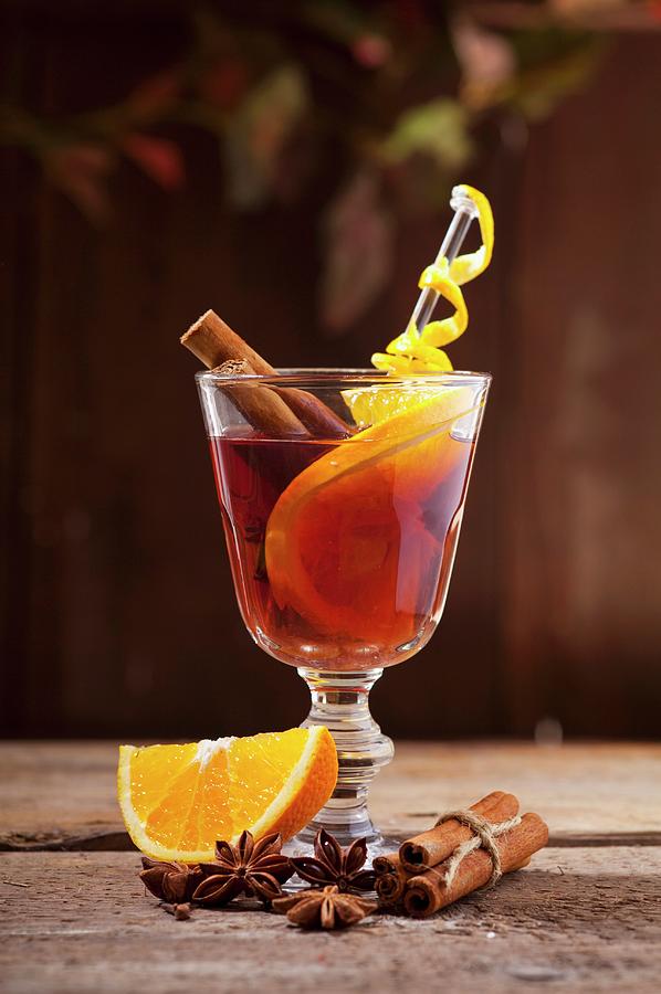 Red Mulled Wine With Oranges, Cinnamon And Star Anise Photograph by Foodografix