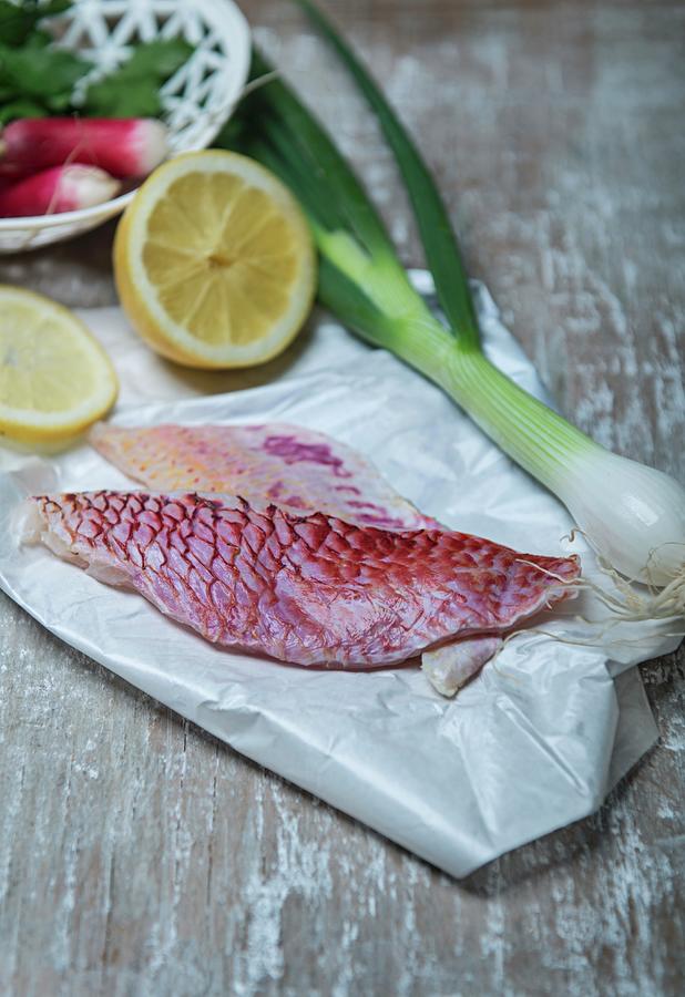 Red Mullet, A Spring Onion, A Lemon And Radishes Photograph by Angelika Grossmann