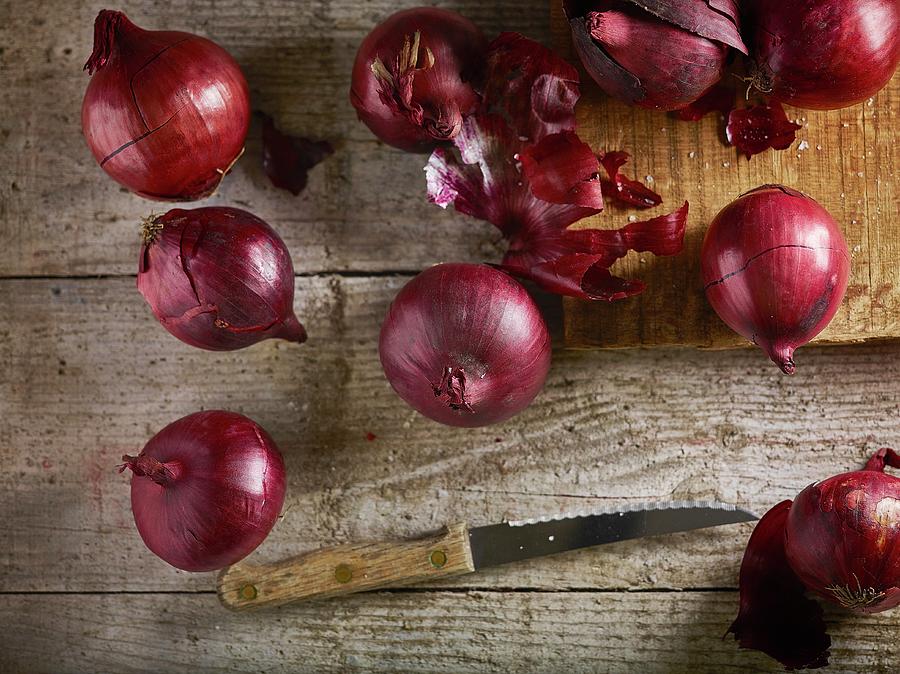 Red Onions On Chopping Board And Wooden Table With Knife Photograph by Artfeeder