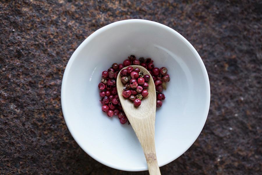 Red Peppercorns With A Wooden Spoon In A Bowl seen From Above Photograph by Nicole Godt