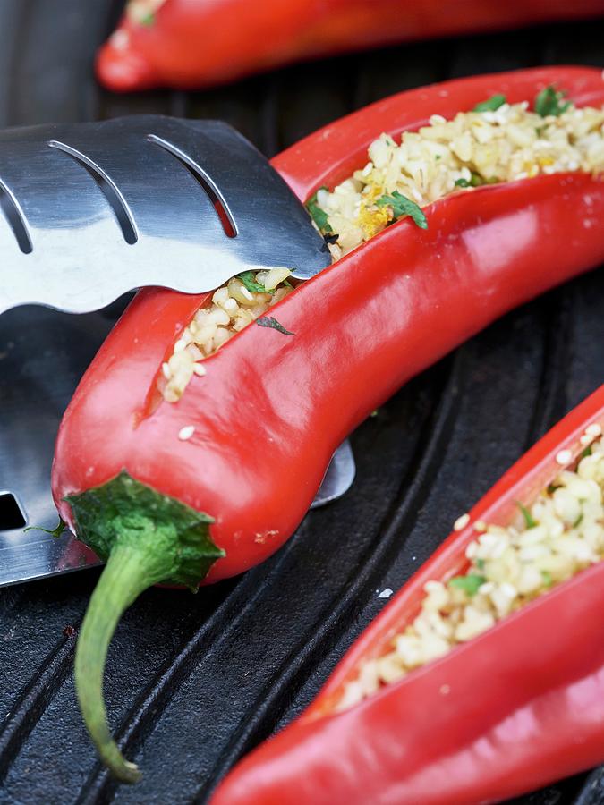 Red Peppers Stuffed With Bulgur Wheat And Herbs On A Grill Photograph by Julia Hildebrand