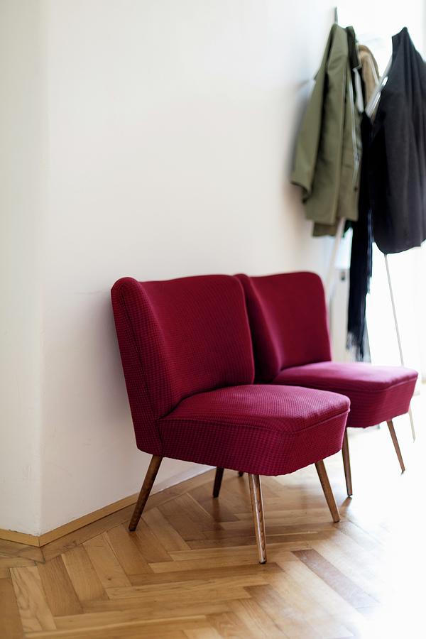 Red, Retro Easy Chairs Next To Coat Rack In Hall Photograph by Wiener Wohnsinn
