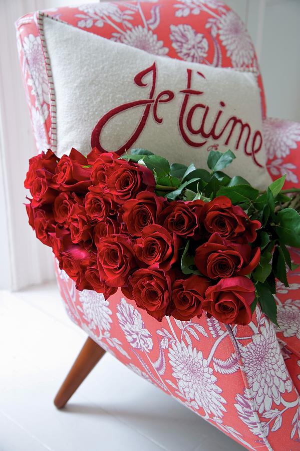 Red Roses And A Cushion With A Love Declaration On An Armchair Photograph by Winfried Heinze