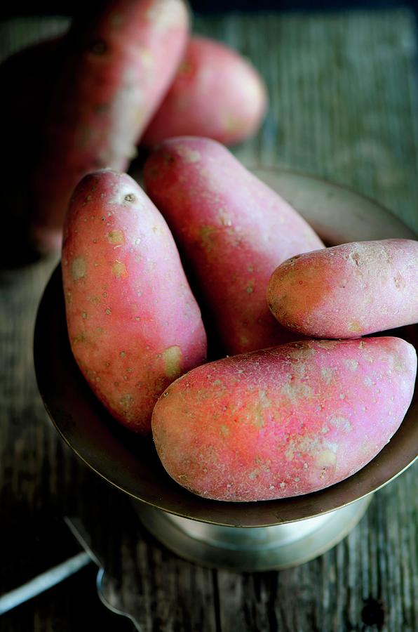 Red Russet Potatoes In A Metal Bowl On A Wooden Surface Photograph by Jamie Watson