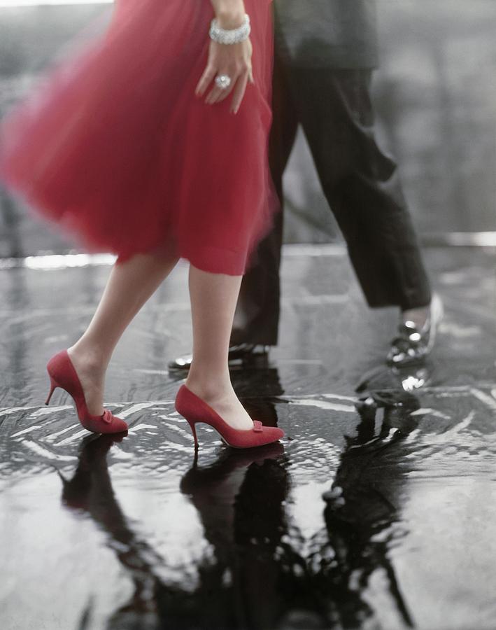 Red Shoes On A Puddle Photograph by Karen Radkai