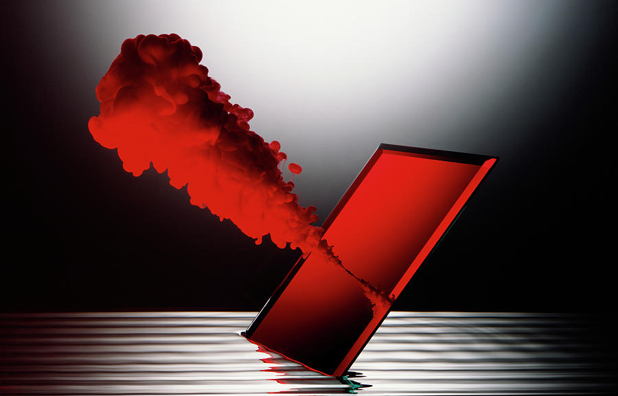 Red Smoke Emitting From Mirror In Water Photograph by Ray Massey