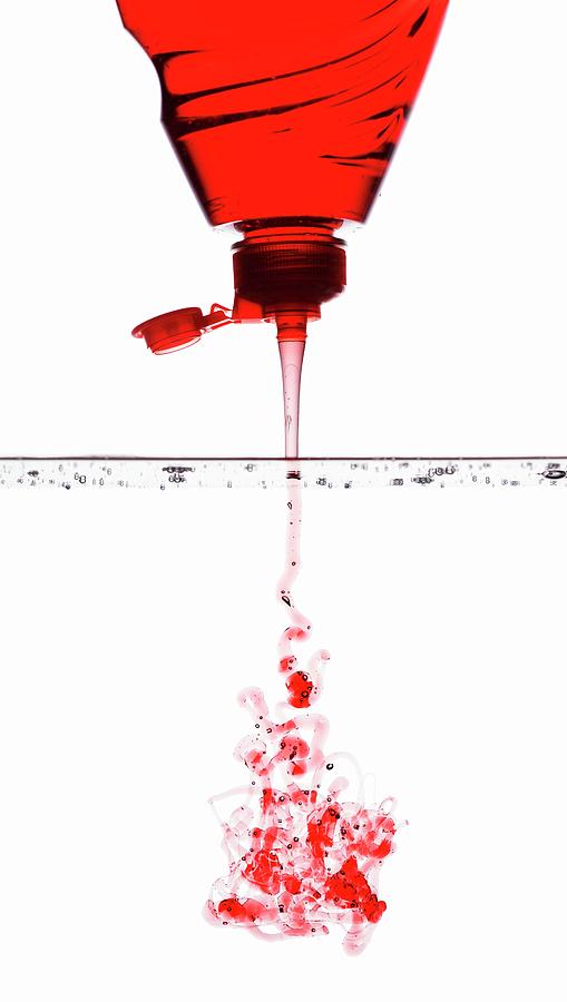 Red Washing-up Liquid Running Into Water Photograph by Krger & Gross