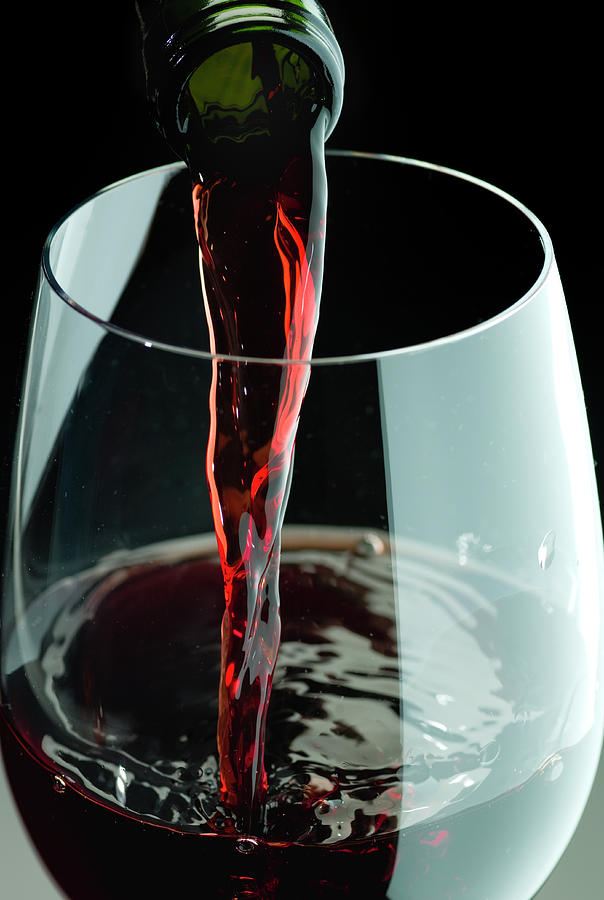 Still Life Photograph - Red Wine Being Poured In A Glass by Juanmonino