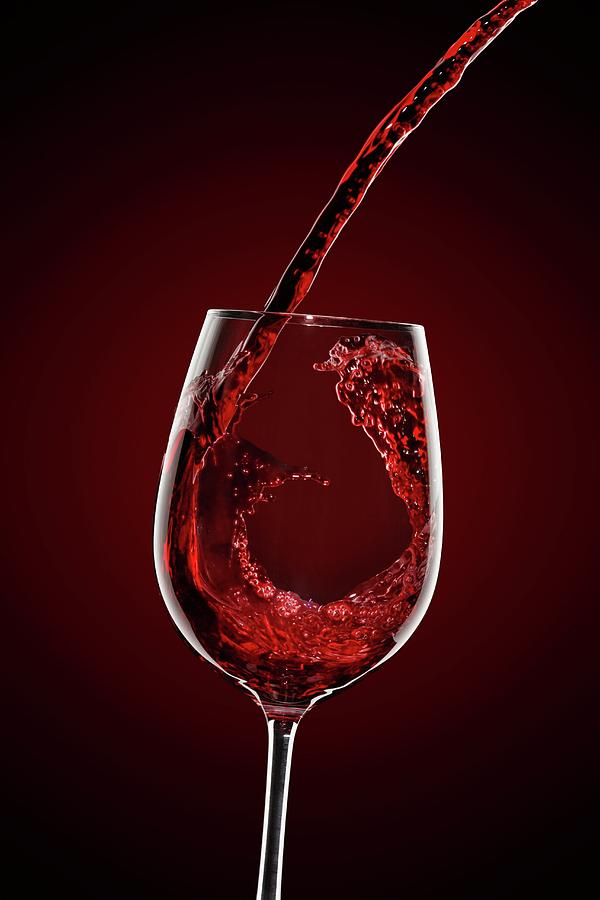 Red Wine Being Pouring Into A Wine Glass Photograph by Krger & Gross