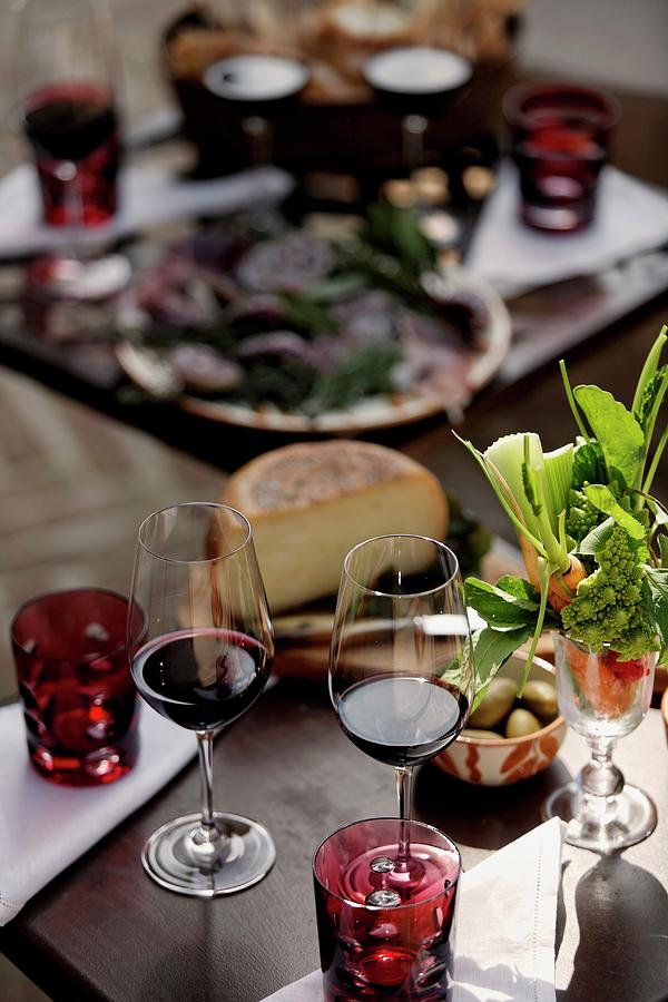 Red Wine Glasses And Starters On A Decorated Table Photograph by Guy Bouchet