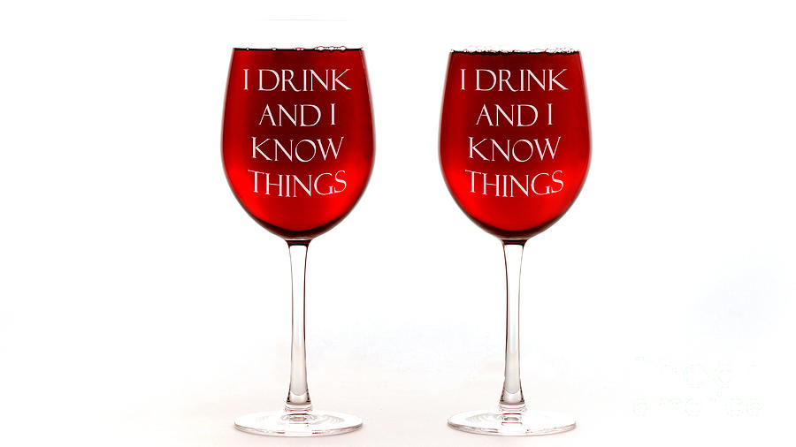 Red wine glasses with I drink and I know things text. Photograph by Milleflore Images