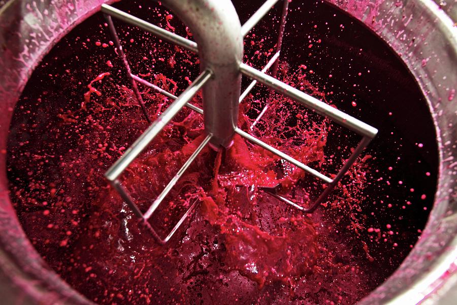 Red Wine Mash Being Aired Using A Mixer And A Pump Photograph by Herbert Lehmann