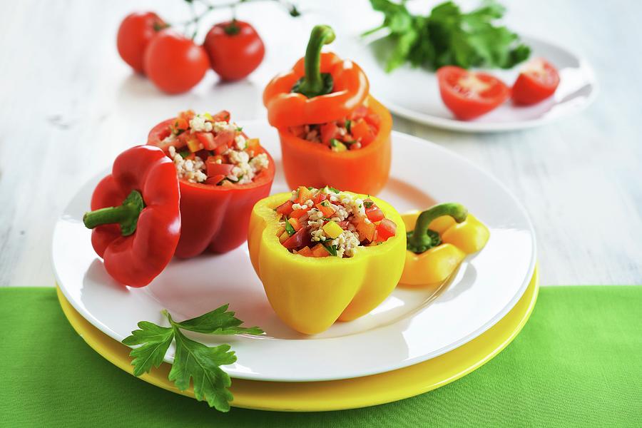 Red, Yellow And Orange Peppers Filled With A Rice, Pepper And Tomato Salad Photograph by Mariola Streim
