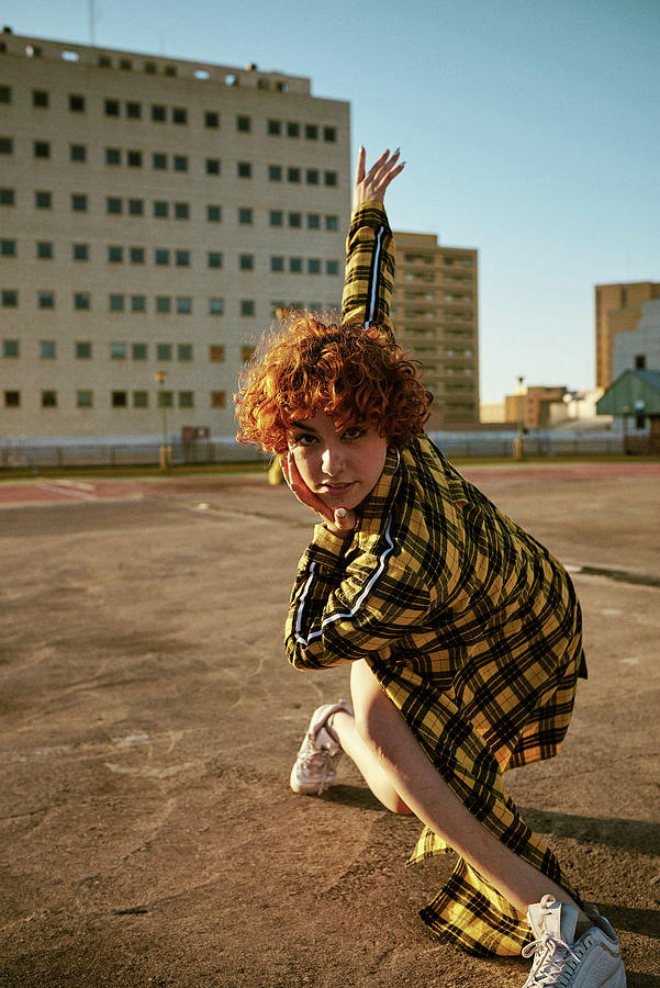 Summer Photograph - Redhead Curly Young Female Dancing In An Empty Parking Lot by Cavan Images