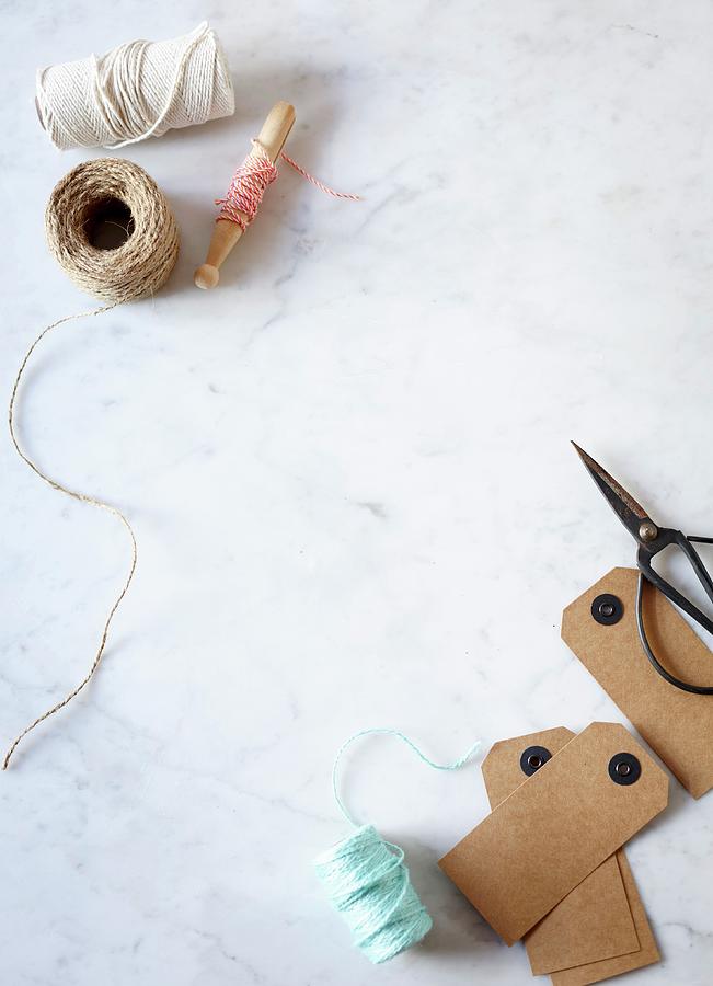 Reels Of Yarn And Twine, Cardboard Labels And Scissors On Marble Table Photograph by Great Stock!