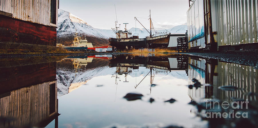 Reflection in a crystalline puddle of aground and old boat. Photograph by Joaquin Corbalan