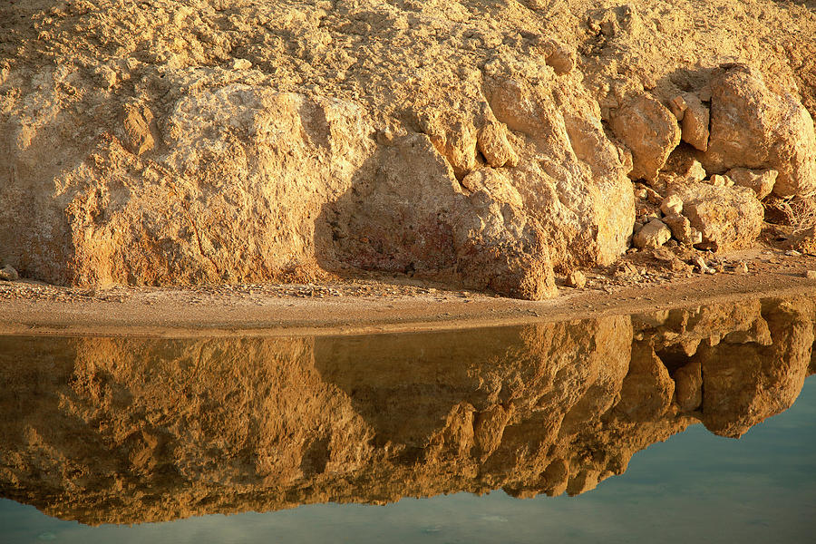 Reflection In Water Of Eroding Cliff Photograph by Timothy Hearsum