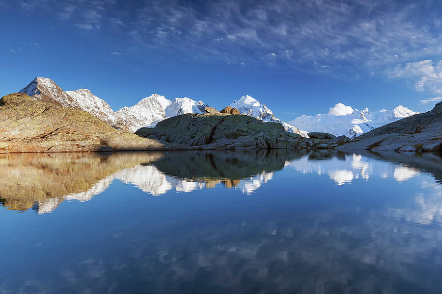 Reflection Of Bernina Range On Mountain Lake, Val Roseg, Engadin, Canton Of Grisons, Switzerland Photograph by Tobias Richter