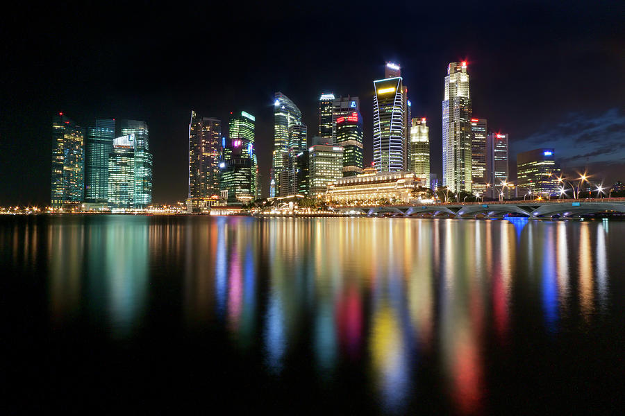 Reflection Of City Builidings At Night Photograph by Xavier Loh