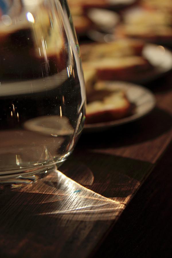 Reflections Of Light In A Jug Of Water On A Wooden Counter In A Restaurant Photograph by Vivi Dangelo