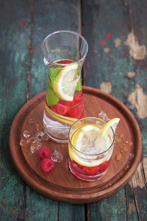 Refreshing Water Flavoured With Raspberries, Lemon And Mint Photograph by Valeria Aksakova