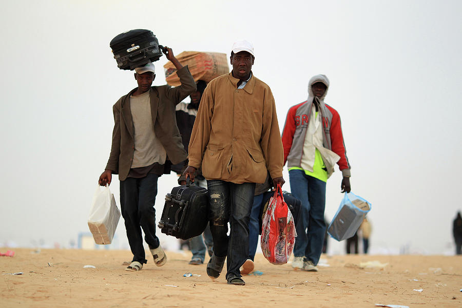 Refugees Cross Tunisian Border To Photograph by Dan Kitwood