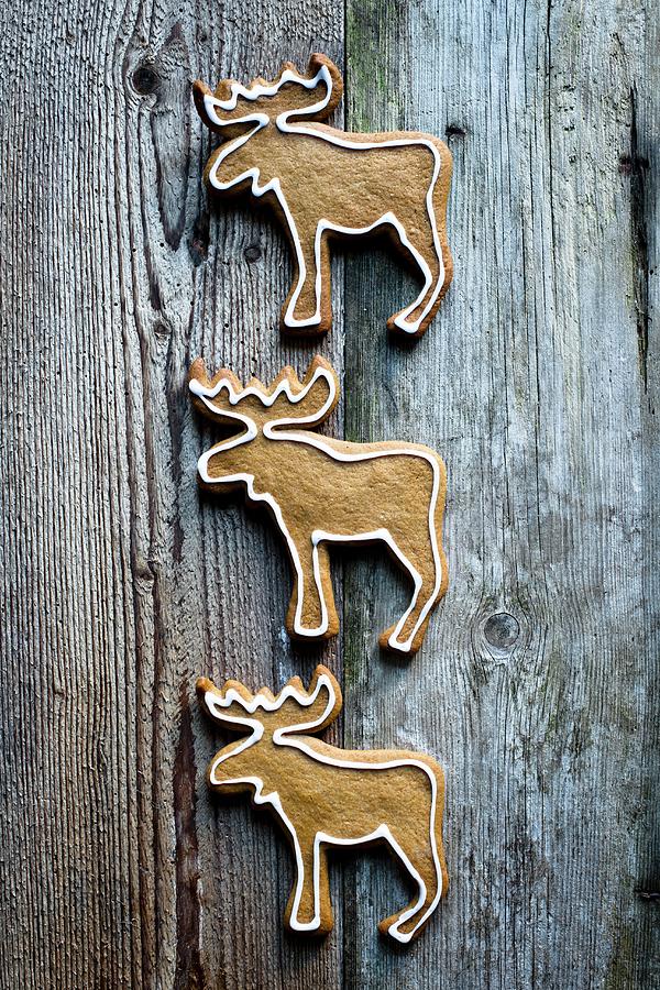 Reindeer-shaped Gingerbread Biscuits On A Wooden Surface Photograph by Magdalena Hendey