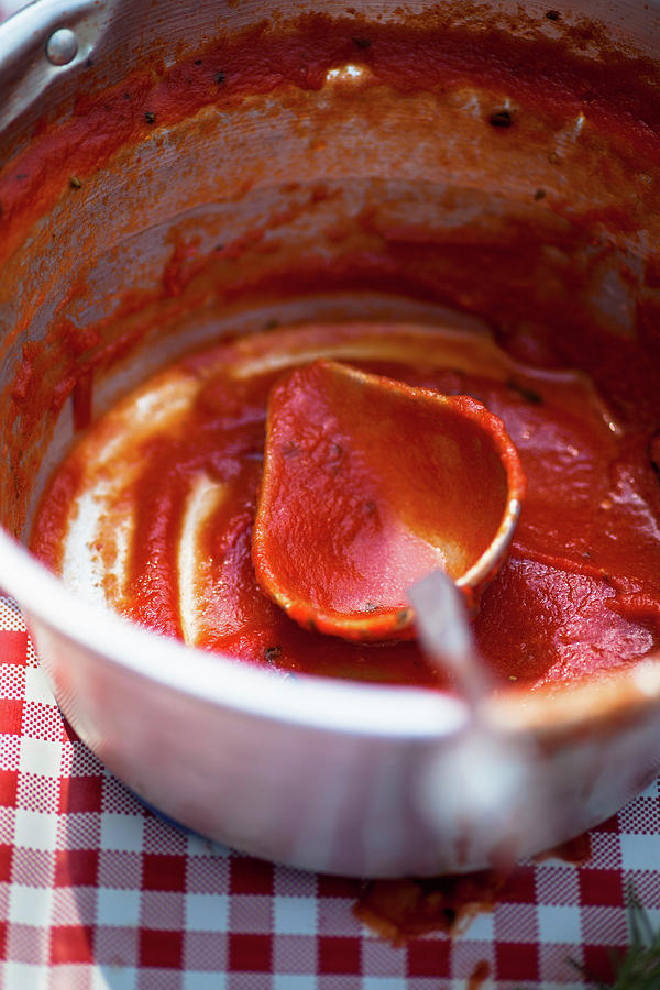 Remains Of Tomato Sugo In A Pot Photograph by Eising Studio
