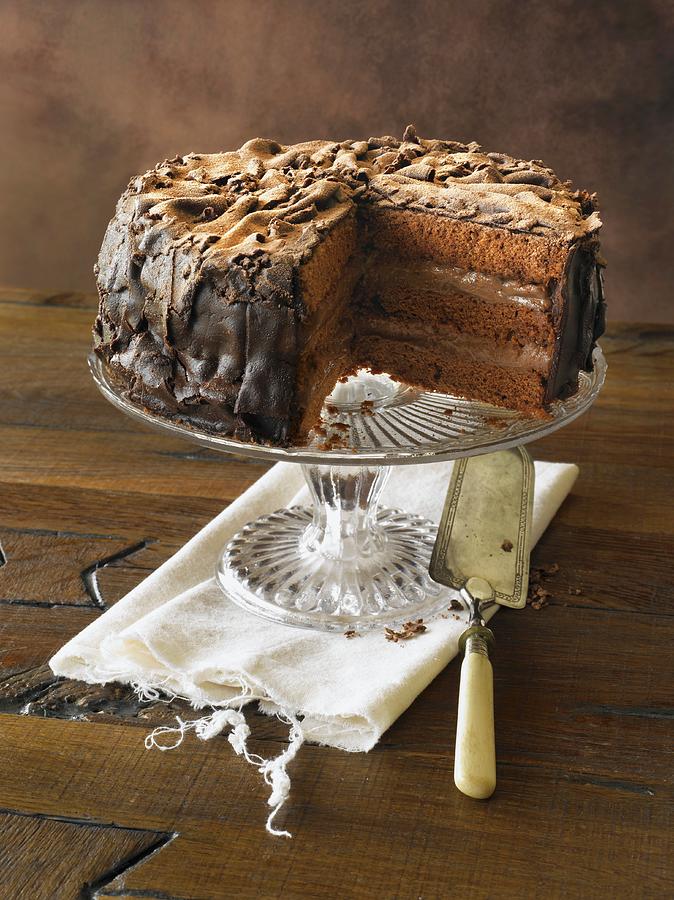 Removing Slice Of Classic Chocolate Cake On Pedestal Dish Photograph by Strmer, Thorsten