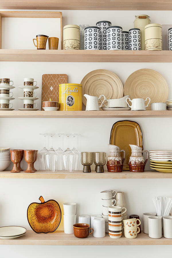 Retro Crockery In Shades Of Brown On Kitchen Shelves Photograph by Studio Lumino