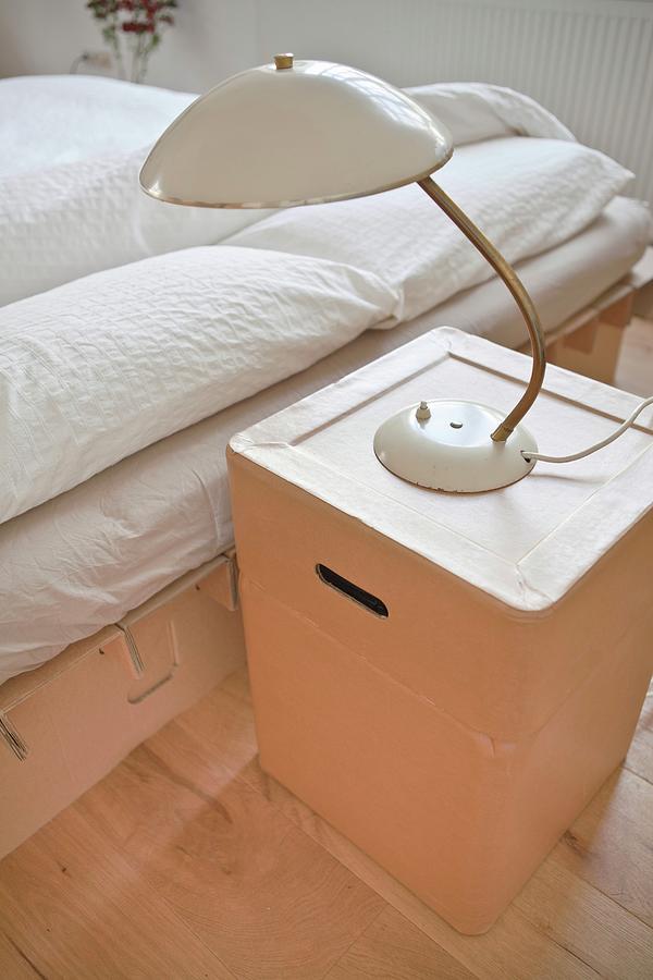 Retro Lamp On Cardboard Bedside Cabinet Photograph by Anne-catherine Scoffoni