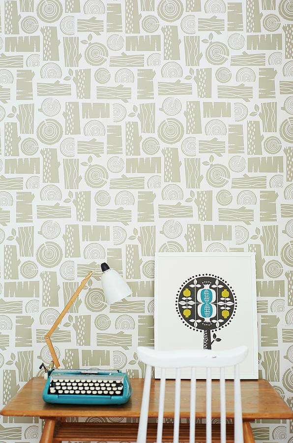 Retro Table Lamp And Typewriter On Wooden Table Against Patterned Wallpaper Photograph by Andrew Boyd