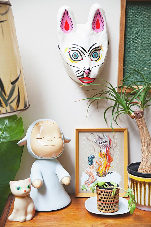Retro Toys, Doll And Cat Ornament Next To House Plant And Below Animal Mask Photograph by Natalie Jeffcott