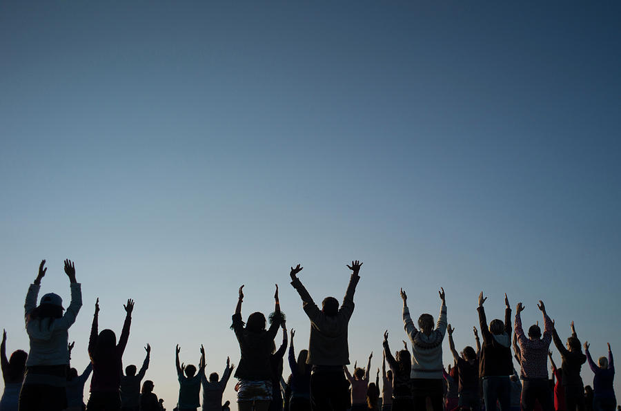 Revellers Perform Yoga Photograph by Kieran Doherty - Fine Art America