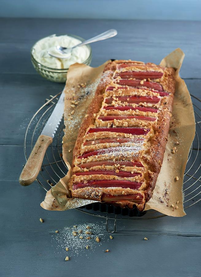 Rhubarb Cake With Marzipan, Wrapped In Baking Paper, On A Cooling Rack Photograph by Stefan Schulte-ladbeck