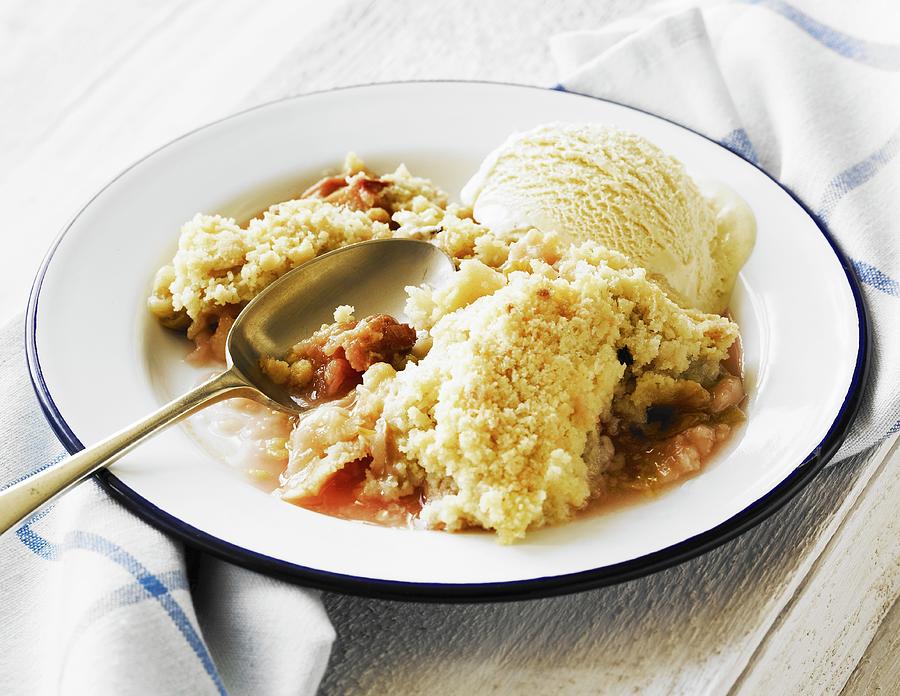 Rhubarb Crumble And Vanilla Ice Cream With Spoon In An Enamel Dish Photograph by Will Shaddock Photography