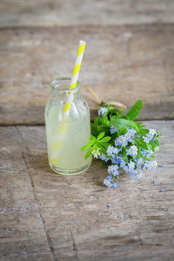 Rhubarb Lemonade In A Mini Glass Bottle Next To A Bouquet Of Forget-me-nots Photograph by Tina Engel