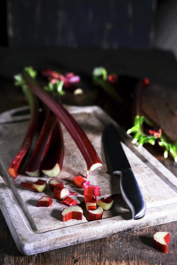 Rhubarb Spears And Pieces With A Knife On A Wooden Board Photograph by Mariola Streim