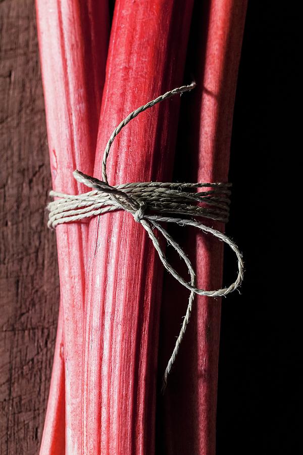 Rhubarb Stalks, Tied In A Bundle, On A Wooden Surface section Photograph by Sarah Coghill