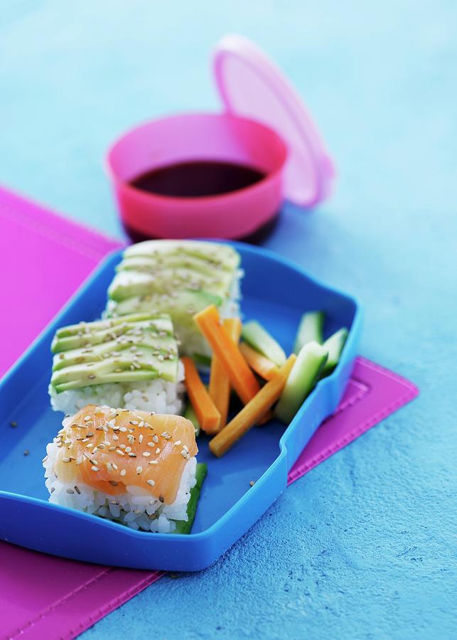 Rice Appetisers With Salmon And Avocado In A Lunch Box Photograph by Mikkel Adsbl