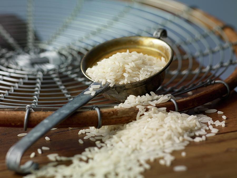 Rice In A Ladle And On A Wooden Table Photograph by Studio R. Schmitz